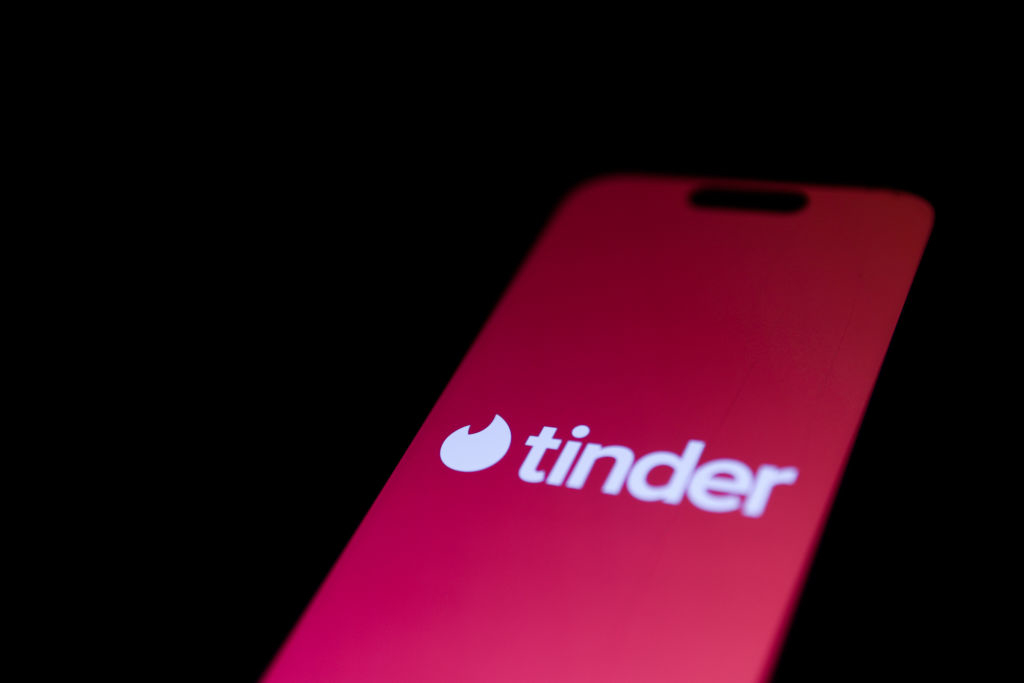 Tinder logo displayed on a mobile phone screen