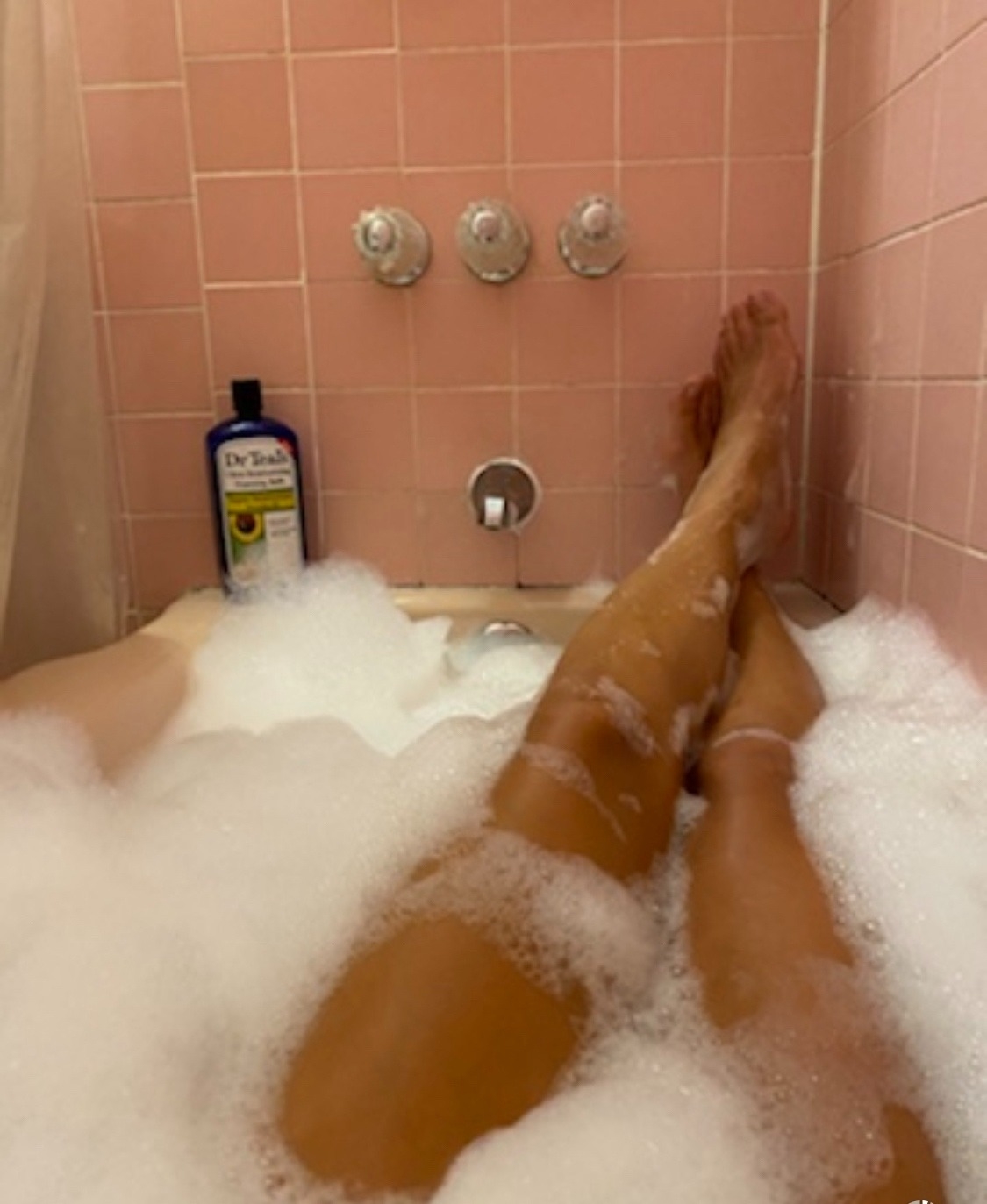 Reviewer relaxing in foaming Dr. Teal&#x27;s avocado oil bubble bath