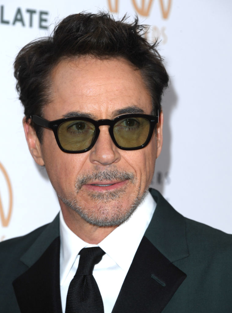 Robert Downey Jr. wearing sunglasses and a dark suit at an event