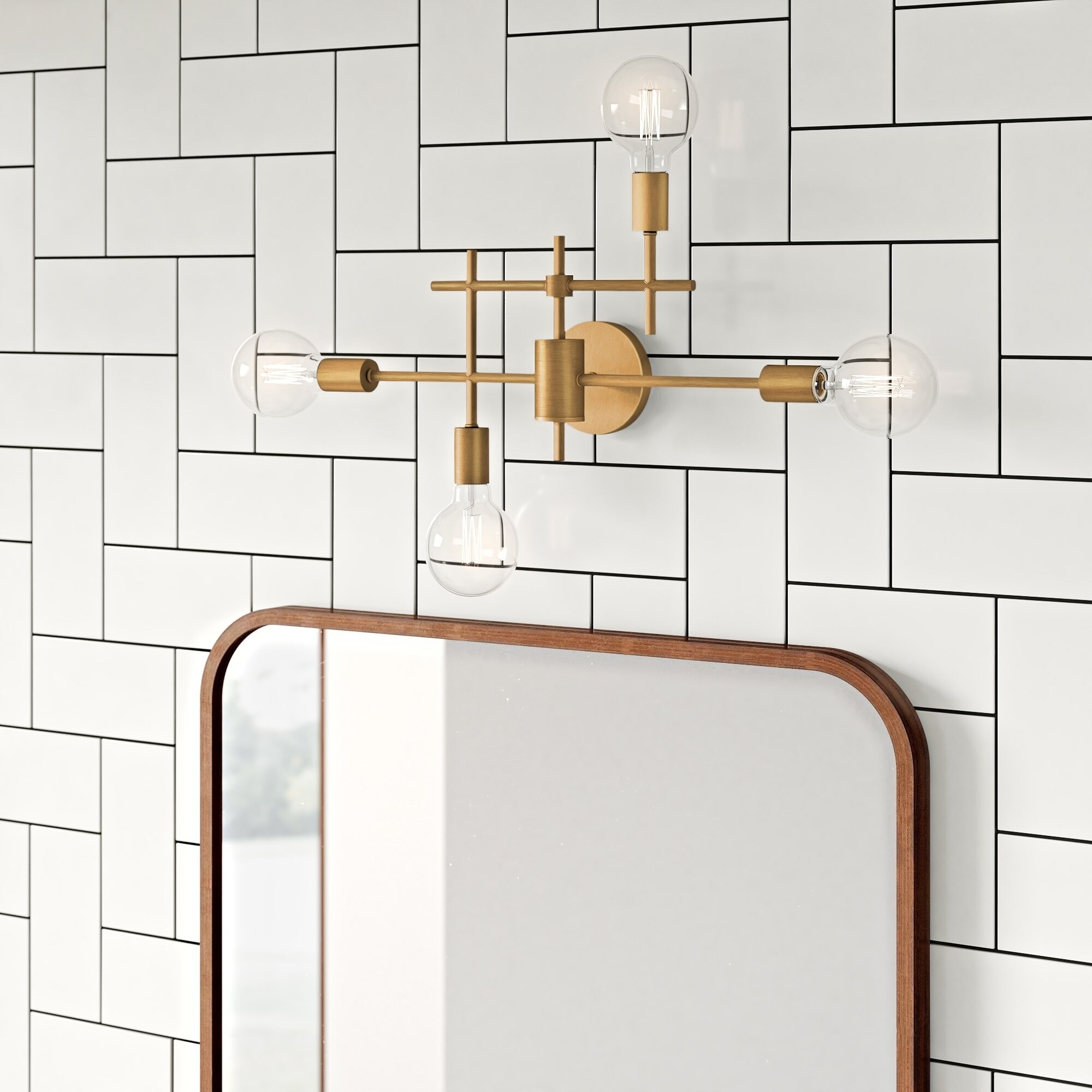 Modern wall-mounted light fixture with three exposed bulbs above a mirror,