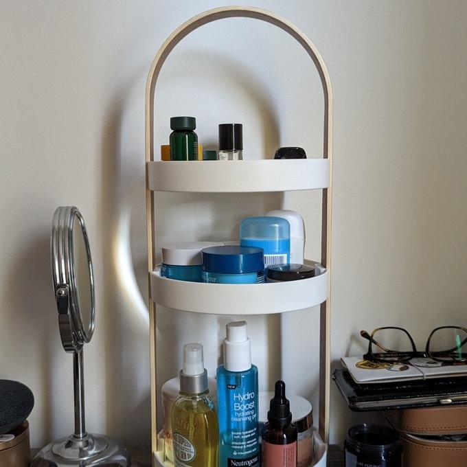Three-tiered storage unit with a variety of skincare products
