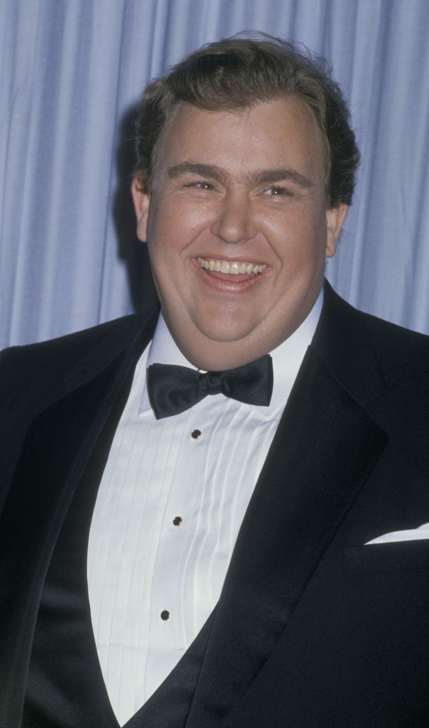 closeup of John Candy smiling man in a tuxedo with a bow tie