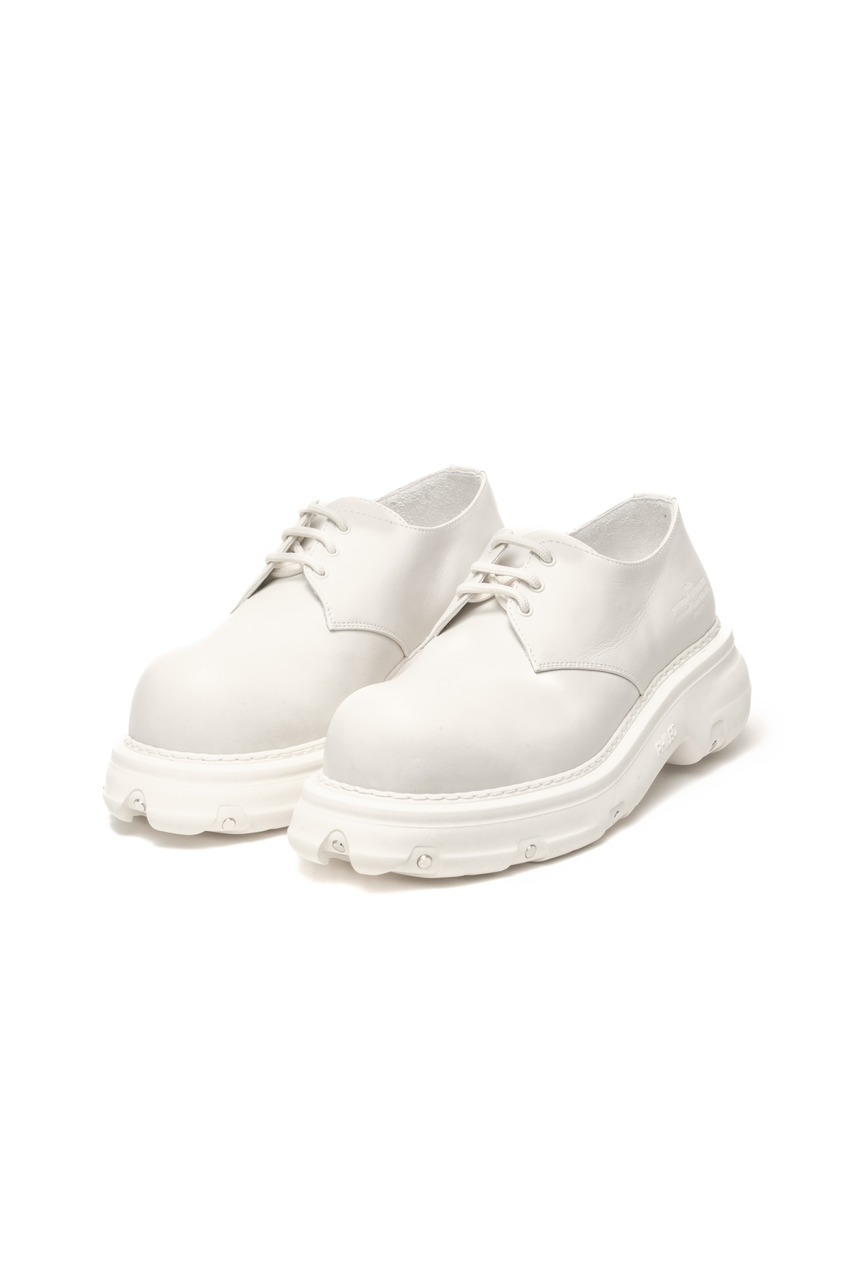 A pair of stylish white platform derby shoes on a plain background