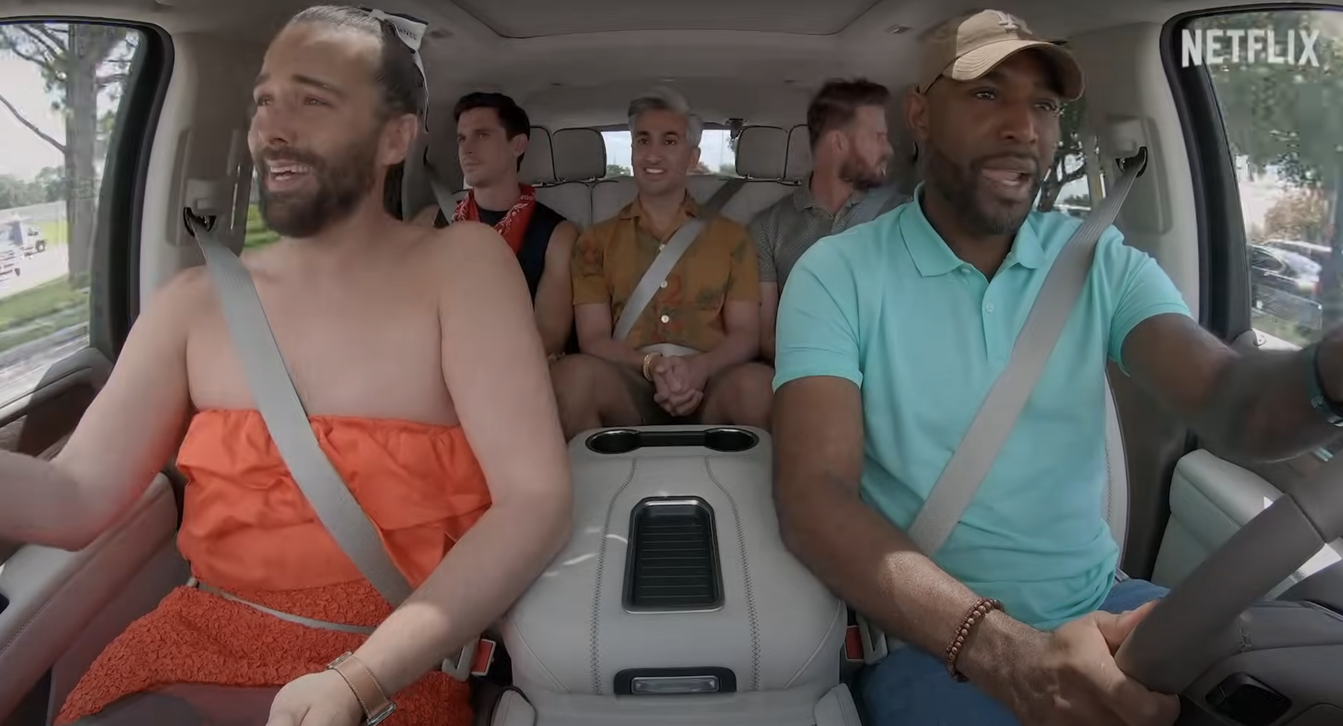 Cast members of &quot;Queer Eye&quot; sitting in a car, with two in the front and three in the back, driving