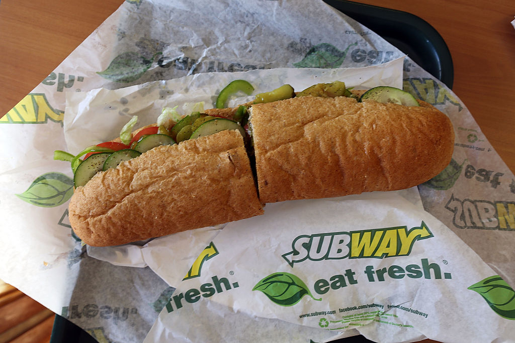 Subway sandwich with vegetables on branded paper