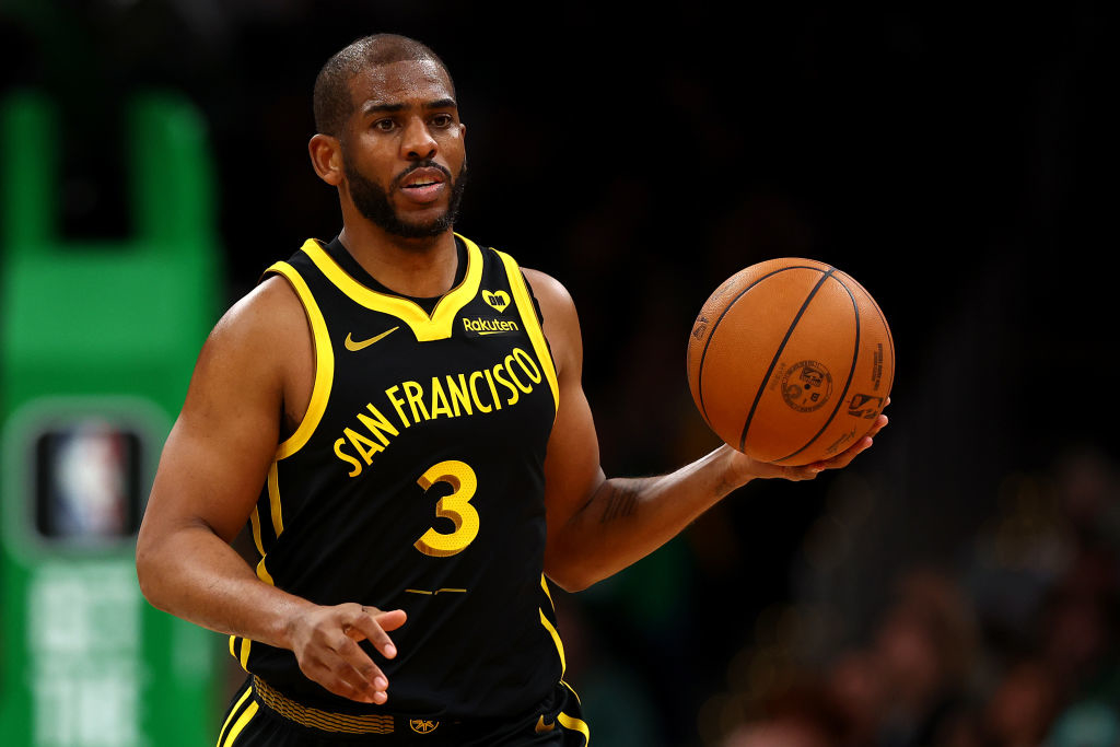 chris paul in his uniform, holding a ball during a game