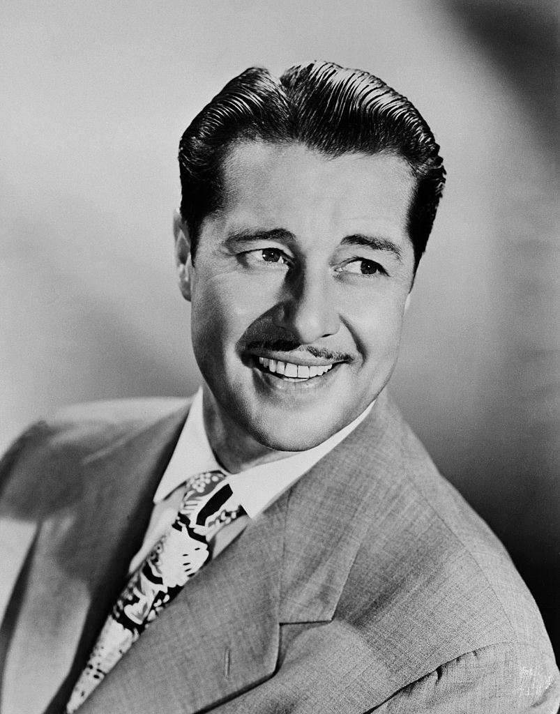 black and white photo of Don with slicked-back hair and patterned tie