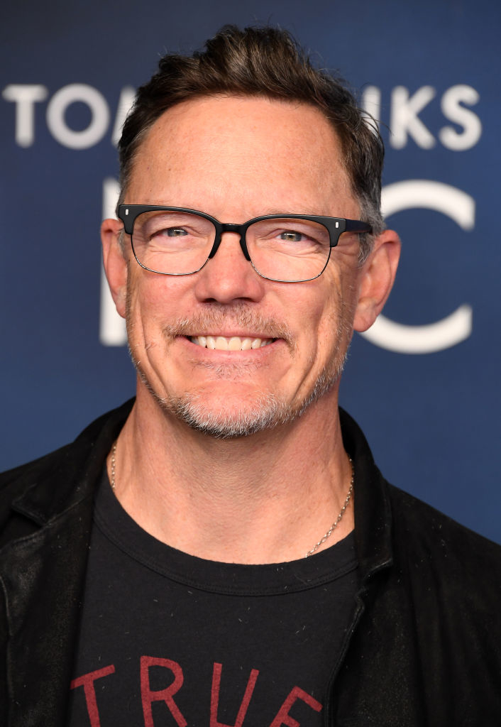 closeup of mattew wearing glasses, smiling at an event