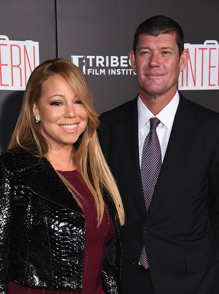 Mariah Carey in a sequined jacket and James in a suit stand side by side