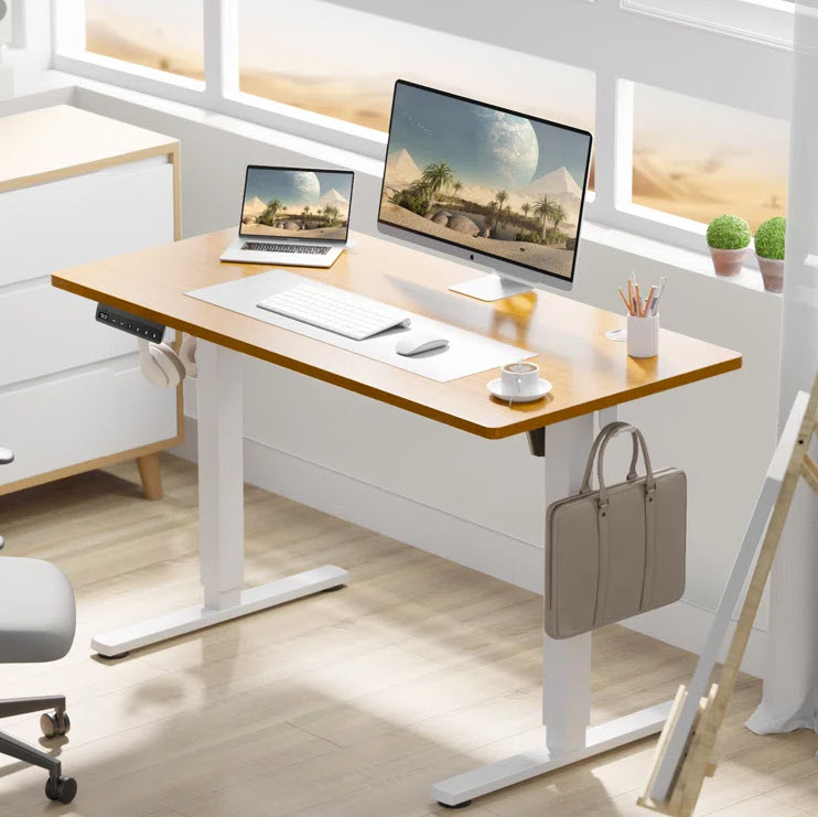 A tidy workspace with a desktop computer, laptop, and various office supplies on a desk