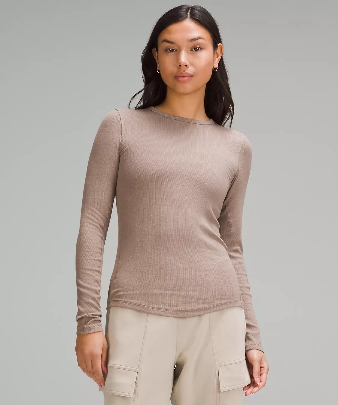 Model wearing ribbed taupe long-sleeve top