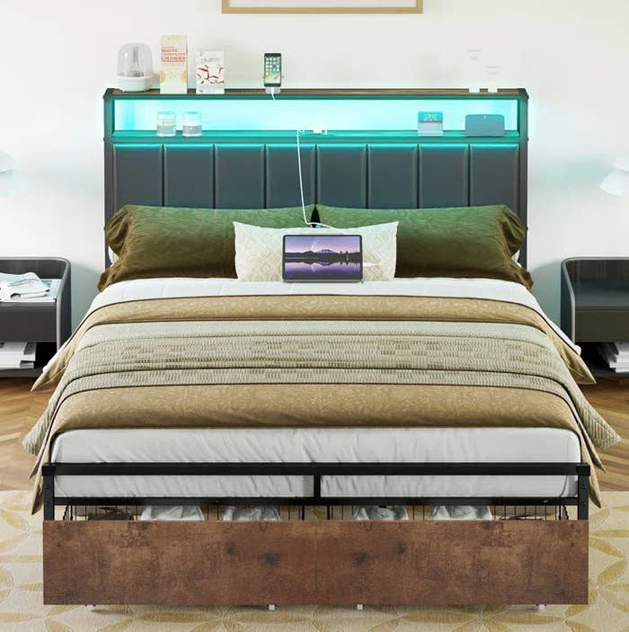 Modern bedroom with a neatly made bed, headboard with built-in shelves, and ambient lighting above