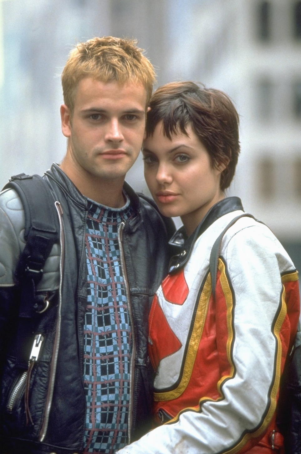 Jonny in a leather jacket and Angie in a red-striped jacket