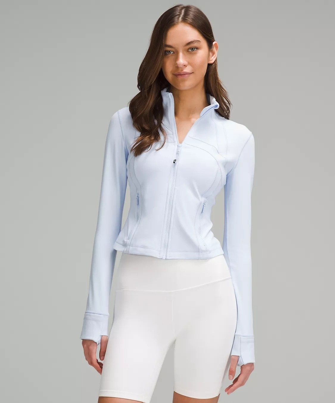 Model wearing light blue cropped zip-up jacket