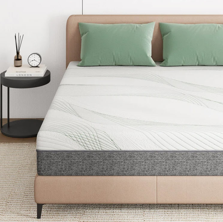 A modern bed with a mattress, two pillows, and a bedside table with a clock