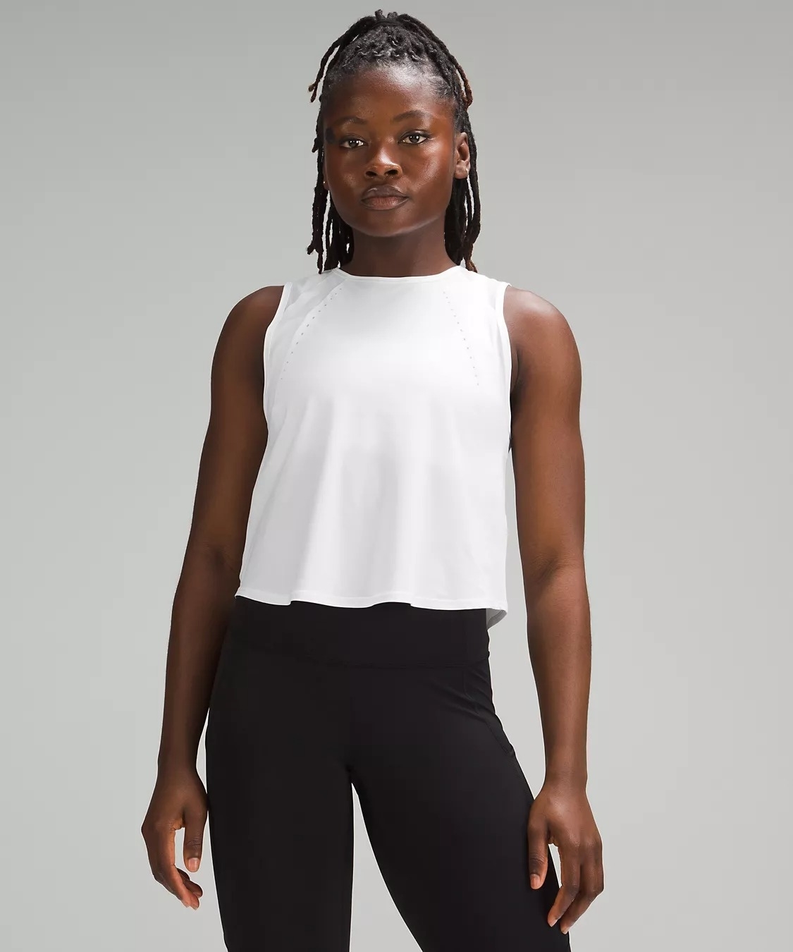 Model in sleeveless white cropped breathable tank