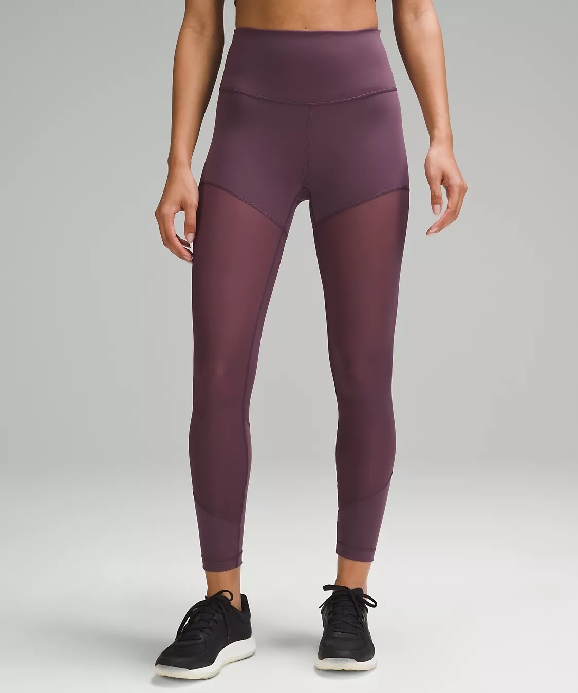 Model wearing dark purple mesh ankle-length leggings