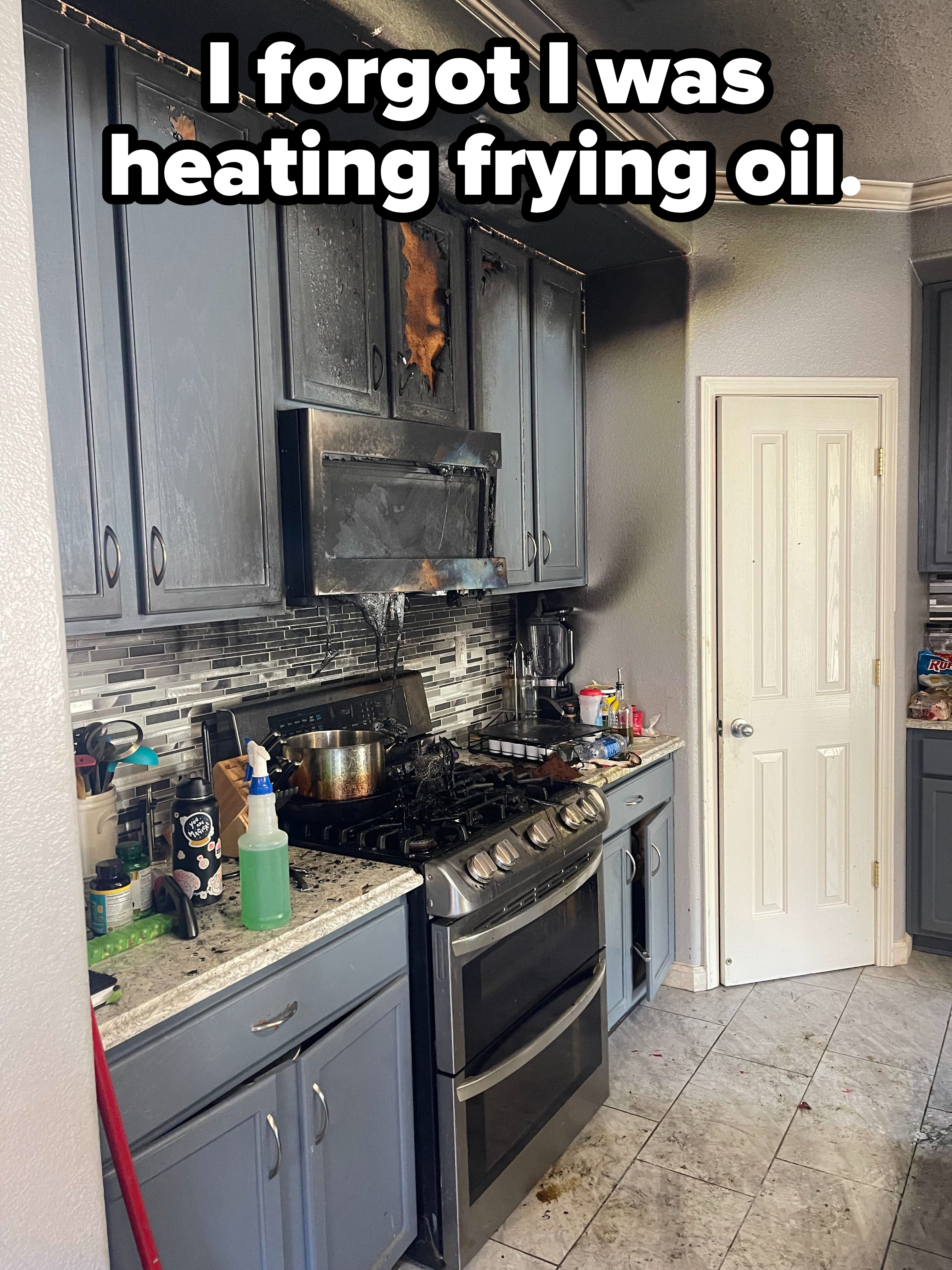Kitchen after a fire with extensive damage to cabinets and walls; burnt cookware on the stove, with caption: &quot;I forgot I was heating frying oil&quot;