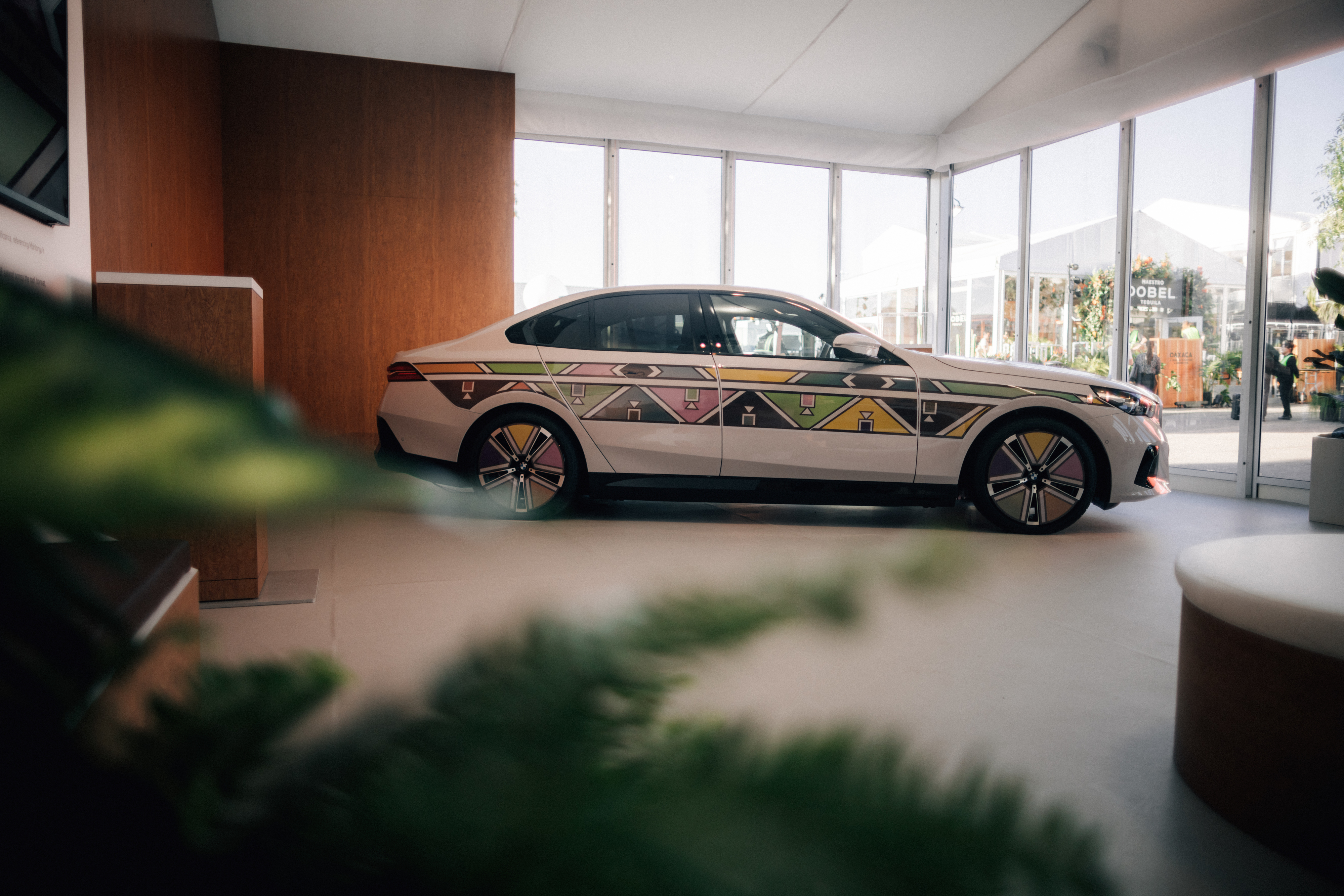 A car with a geometric pattern design parked inside a modern building