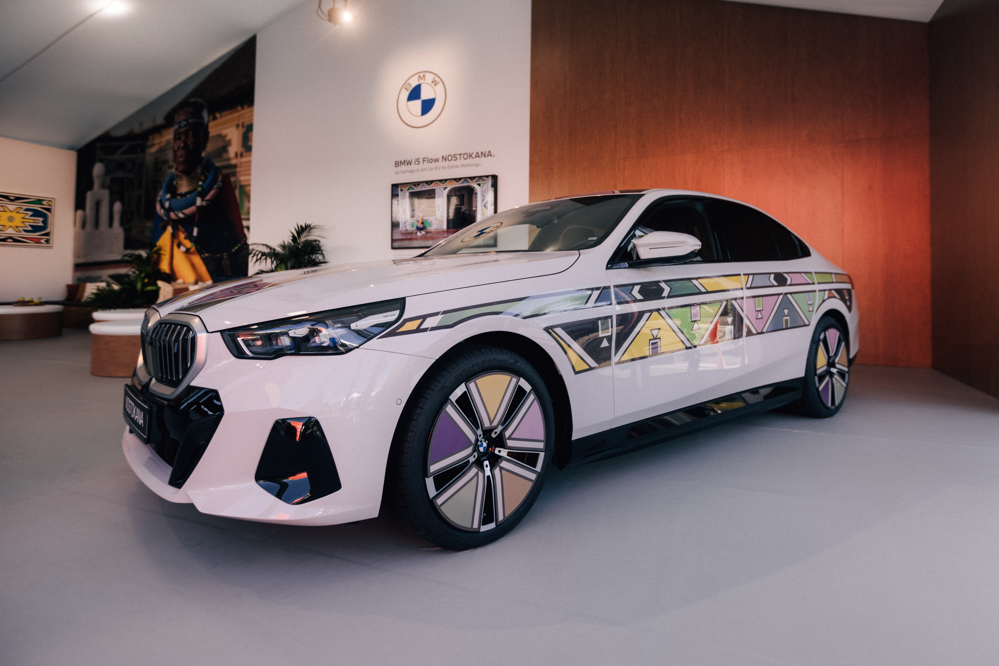 BMW car with a unique geometric pattern displayed in an indoor setting, no people in the image