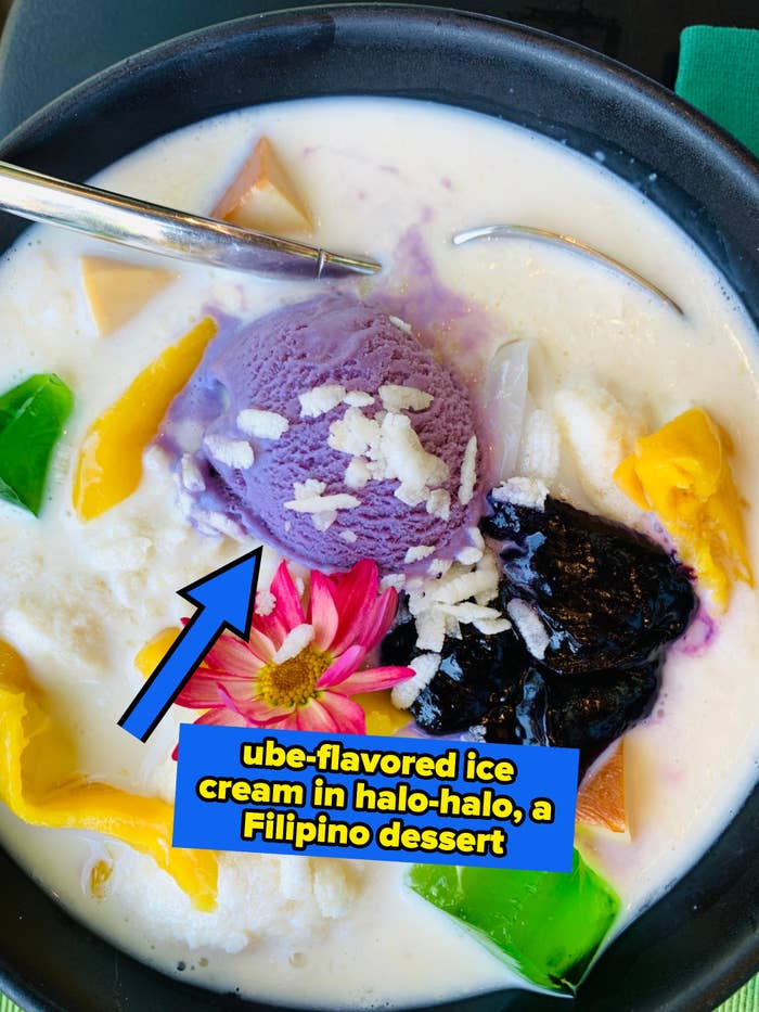 A bowl of halo-halo with mixed ingredients, including ube ice cream, jellies, and a spoon