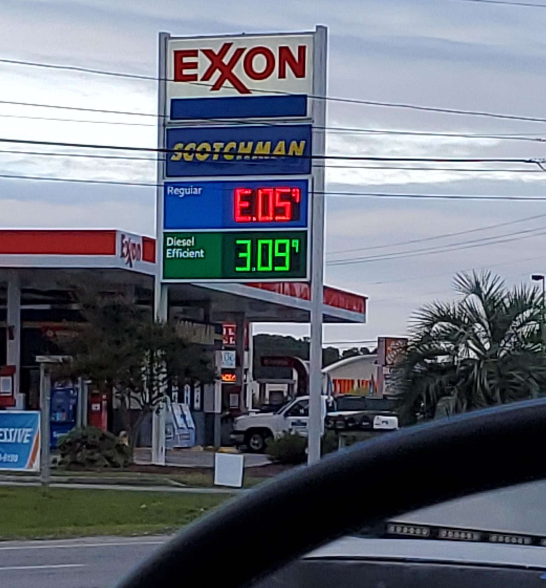 A gas station sign with the price backwards