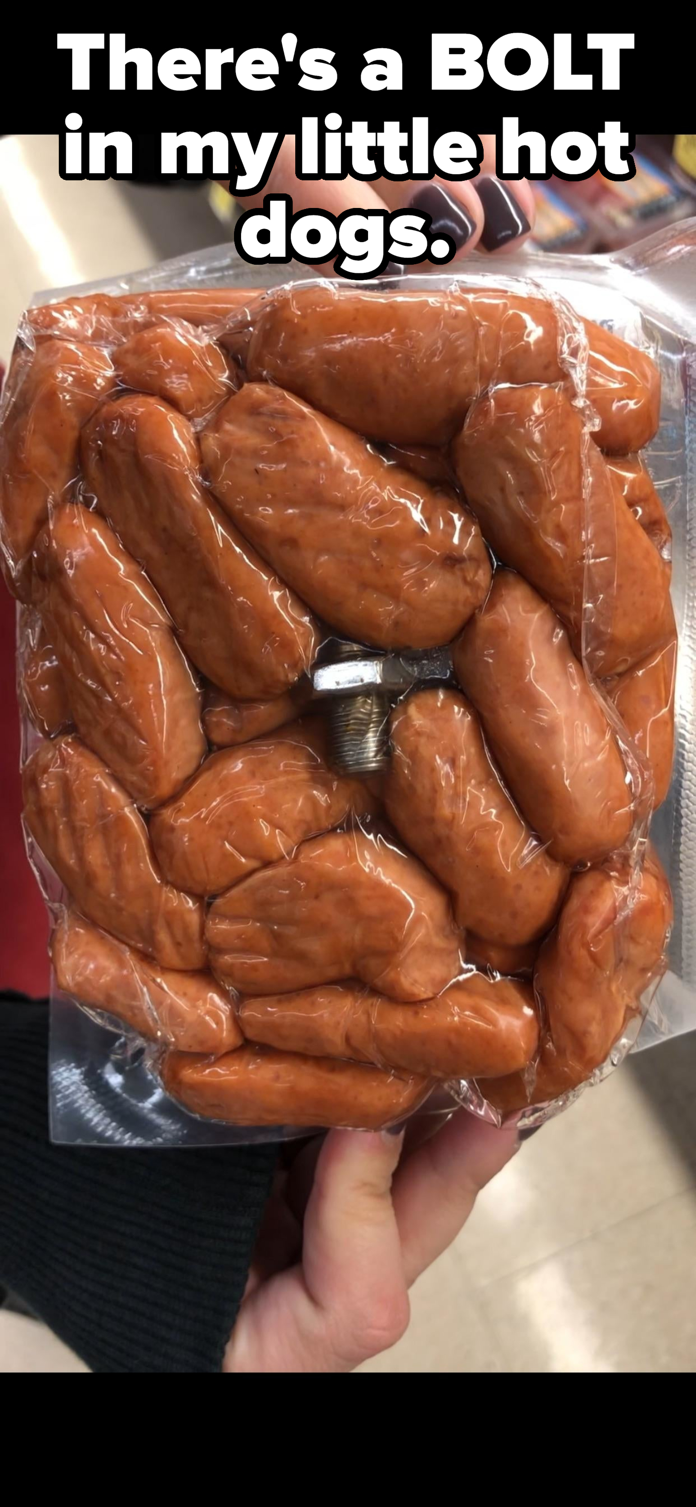Hand holding a package of mini smoked wieners containing a thick bolt with caption &quot;There&#x27;s a BOLT in my little hot dogs&quot;