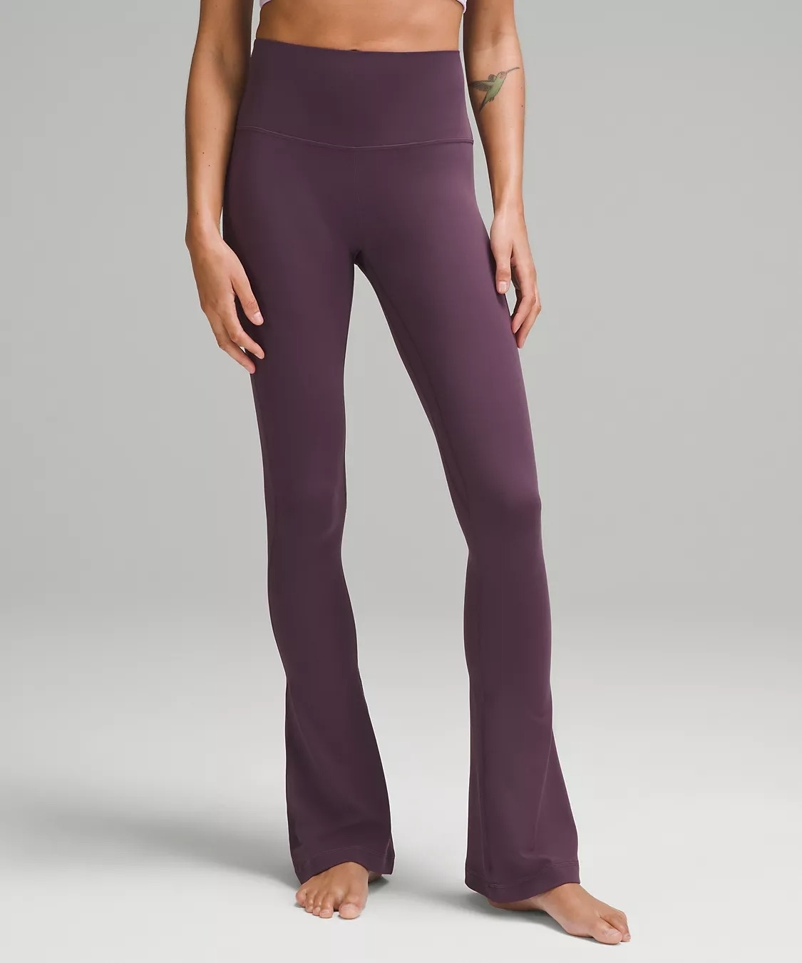 model wearing flared purple high-rise leggings