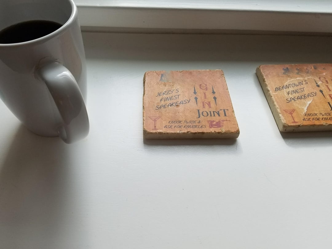 a cup next to two coasters