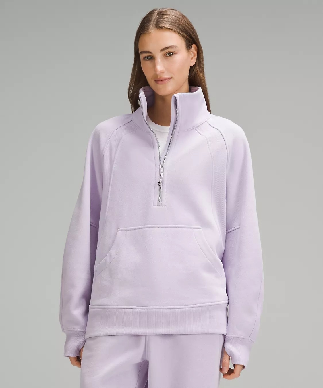 Model wearing light purple funnel-neck sweatshirt
