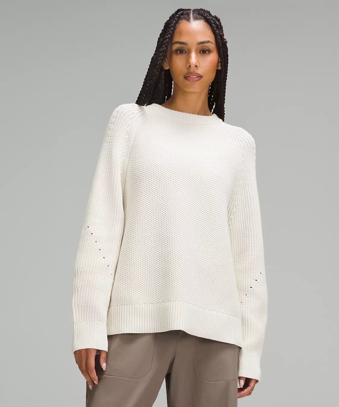 Model wearing a textured white sweater