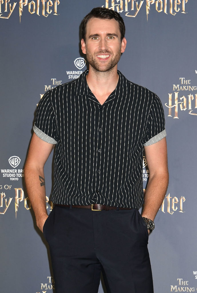 Matthew Lewis in a striped shirt and trousers at Harry Potter event