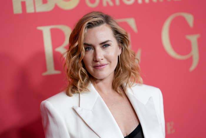 Kate Winslet at an event posing on the red carpet in a blazer