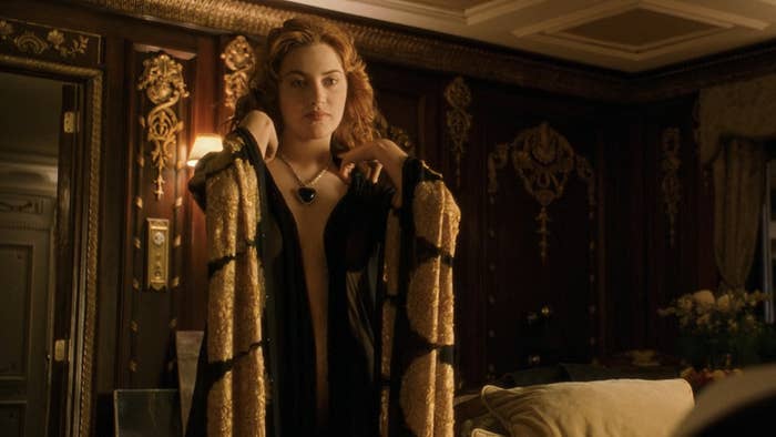 Kate in an elegant robe preparing for an event in a luxurious room in a scene from Titanic