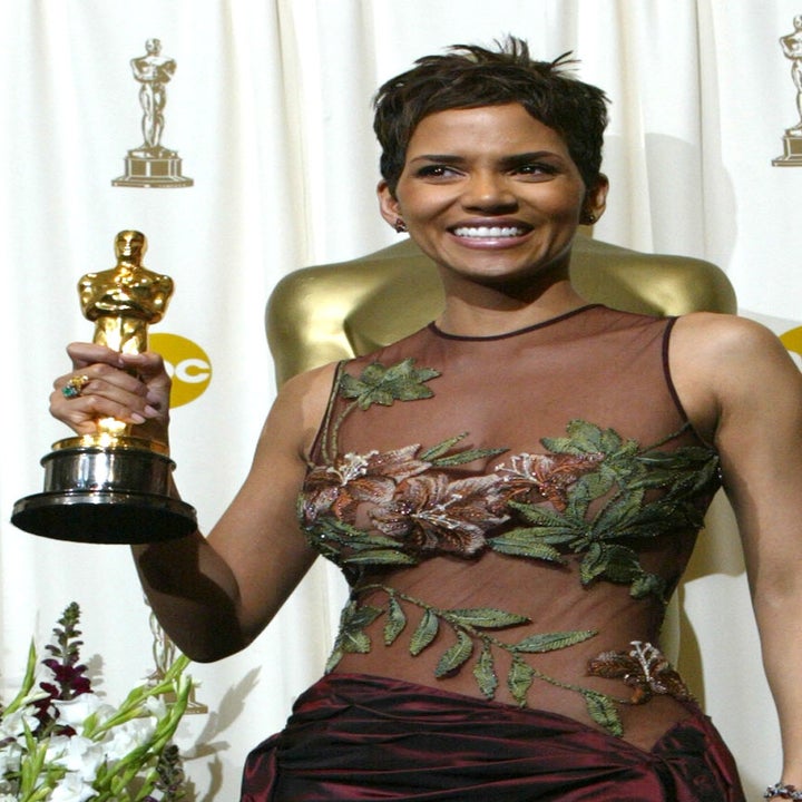 Halle Berry in a burgundy dress holding an Oscar trophy