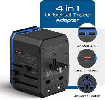 Black 4-in-1 travel adapter with USB and USB-C ports, and interchangeable plugs for international use