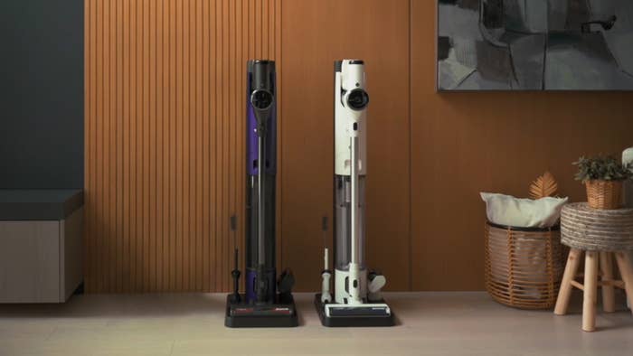Two vacuum cleaners side by side in a room with modern decor