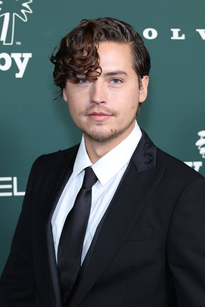 Closeup of Cole Sprouse in a suit and tie