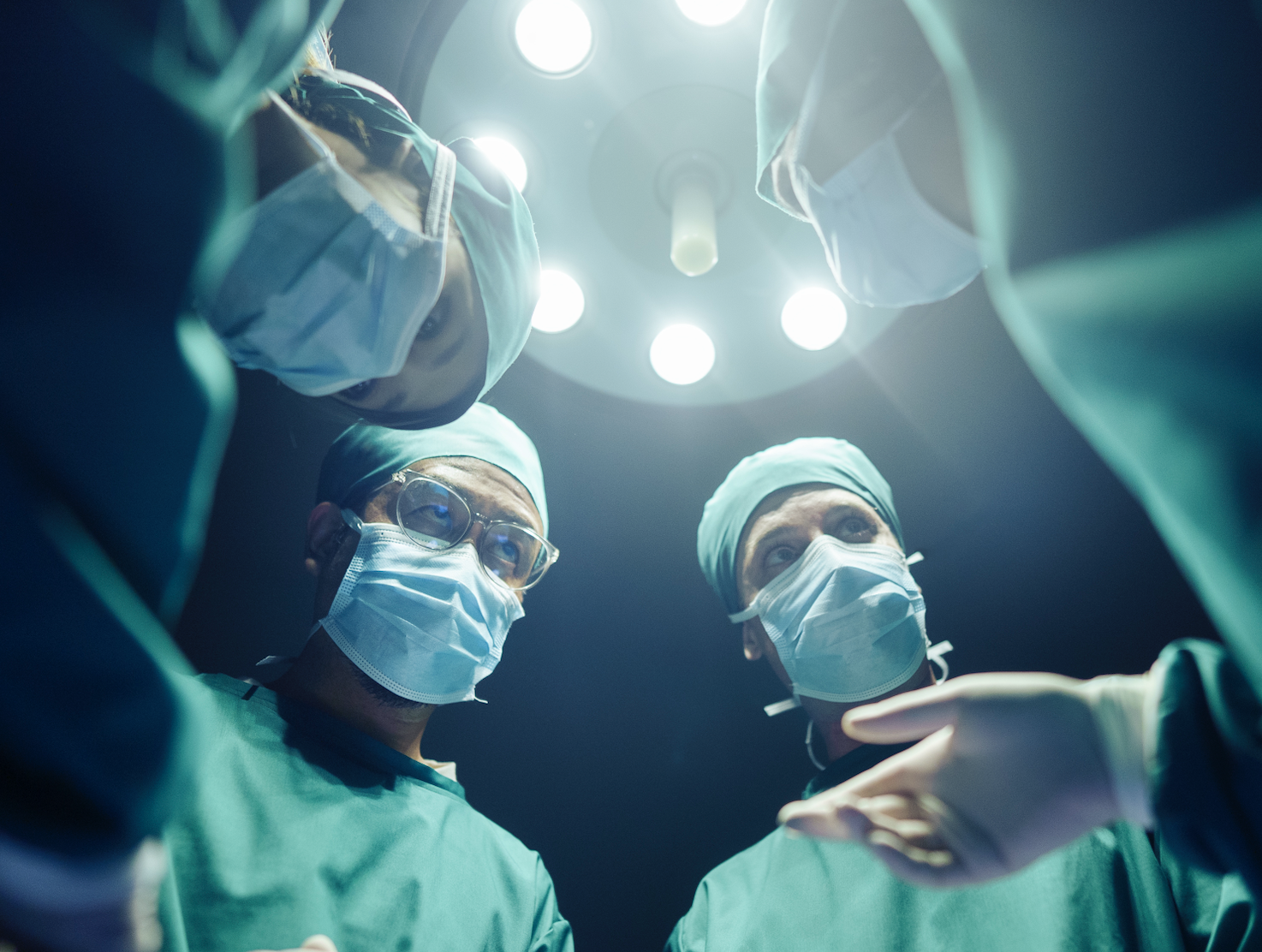 Medical team performing surgery, viewed from patient&#x27;s perspective