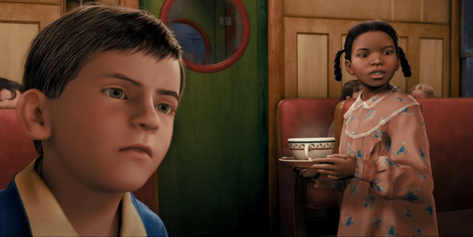 Two animated characters, a boy and a girl, inside a train cabin with a cupcake