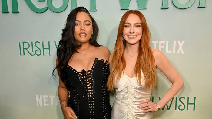 Ayesha Curry and Lindsay Lohan in elegant dresses posing together at an event