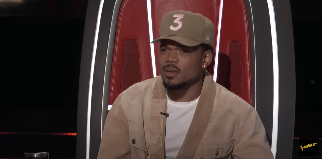 Chance the Rapper in a jacket and cap, sitting in a red chair on &#x27;The Voice&#x27;