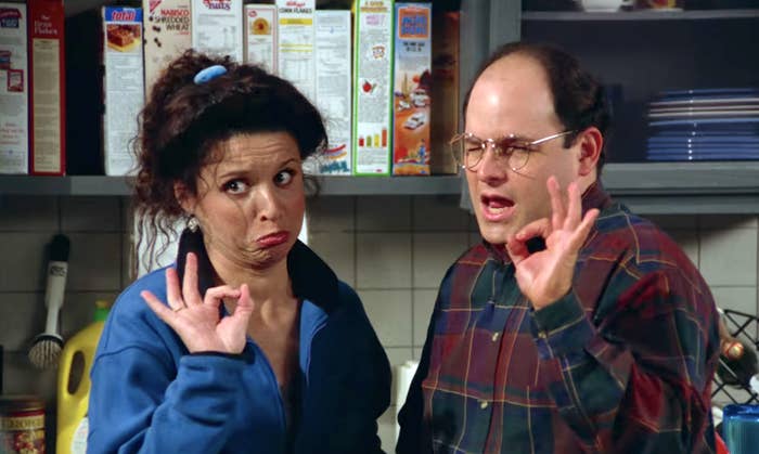 Elaine and George from &quot;Seinfeld&quot; in a kitchen, looking confused; Elaine gestures while George holds fingers up