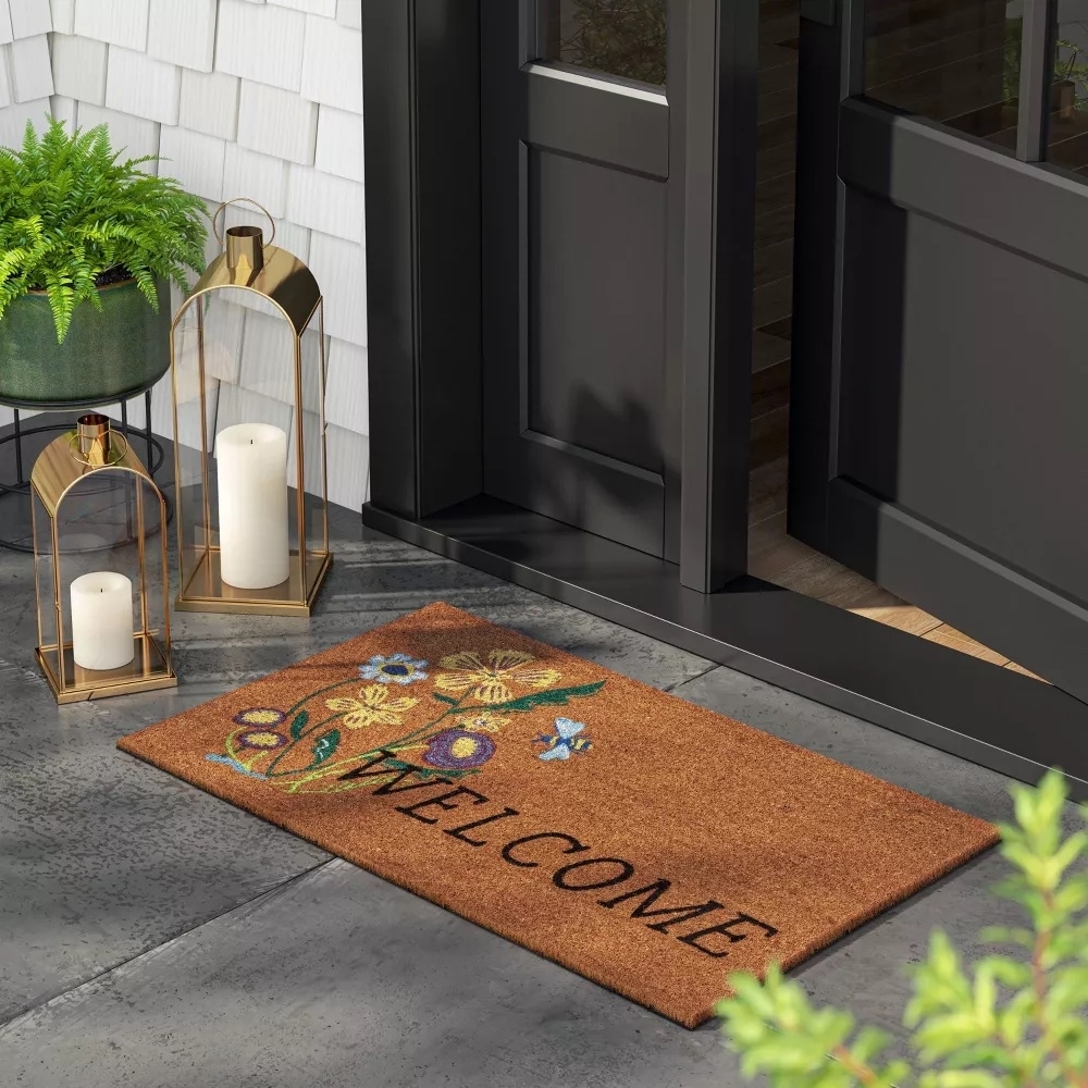 A welcome mat with floral design at a front door, ideal for a stylish home entrance