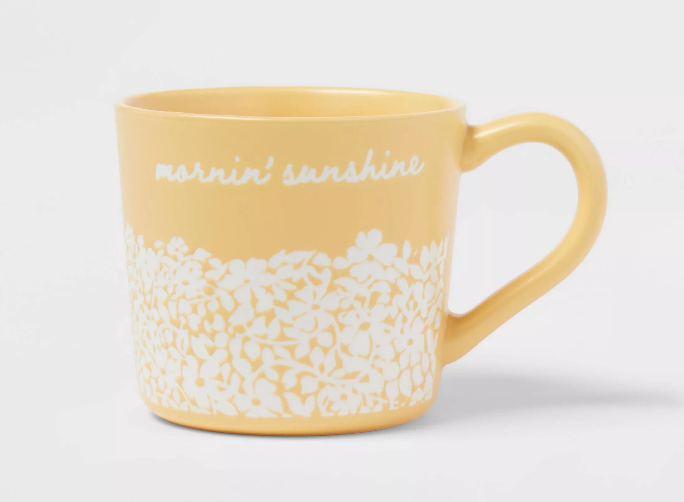 Yellow ceramic mug with floral pattern and &quot;morning’s sunshine&quot; text