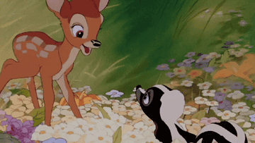 Bambi the deer and Flower the skunk from the Disney film Bambi talking to each other happily in a bed of flowers