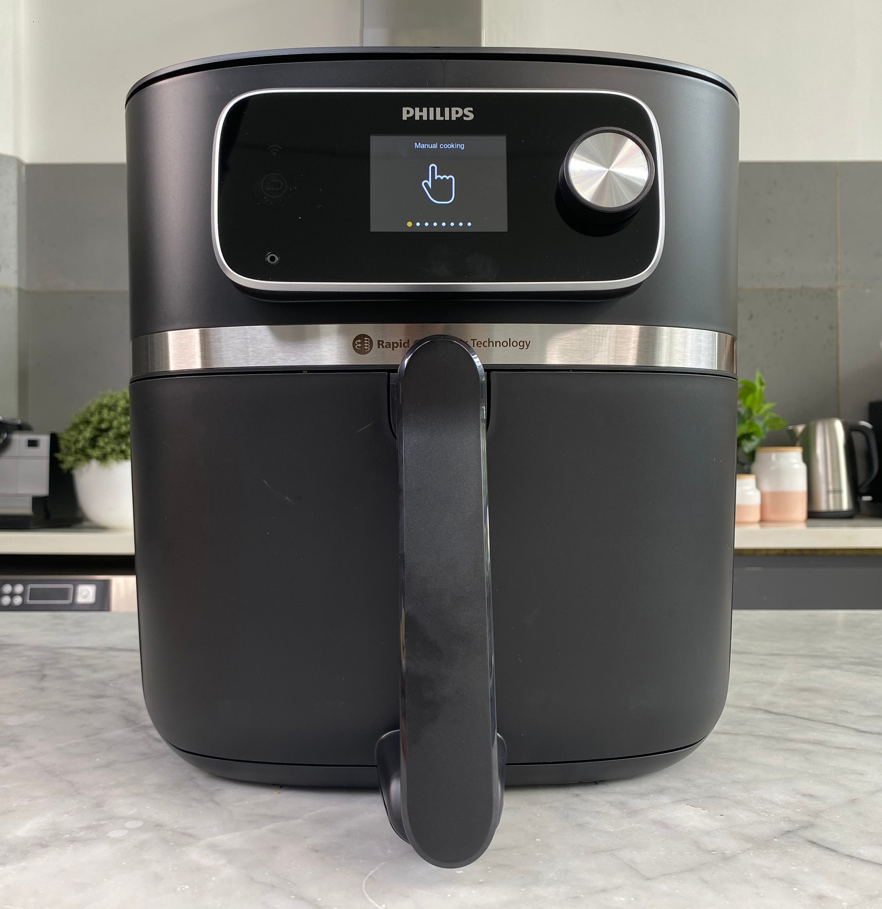 A Philips air fryer sits on a kitchen counter