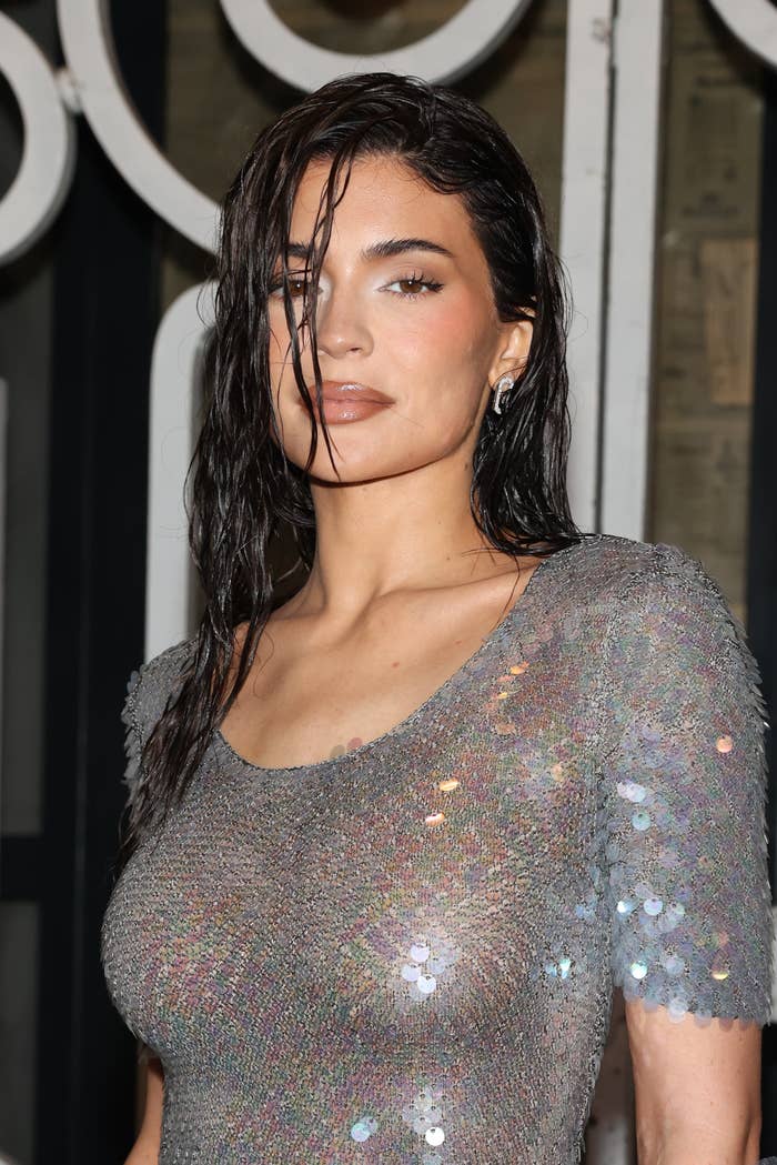 Kylie in a shimmering sequined dress posing for the camera