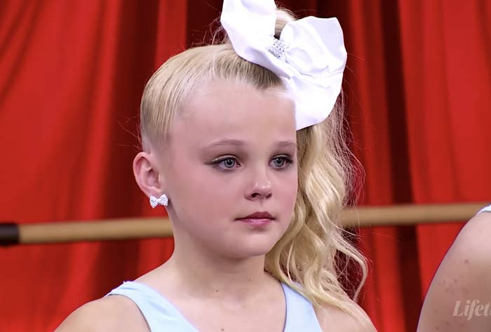 JoJo Siwa as a child with a bow in her hair in a scene from Dance Moms