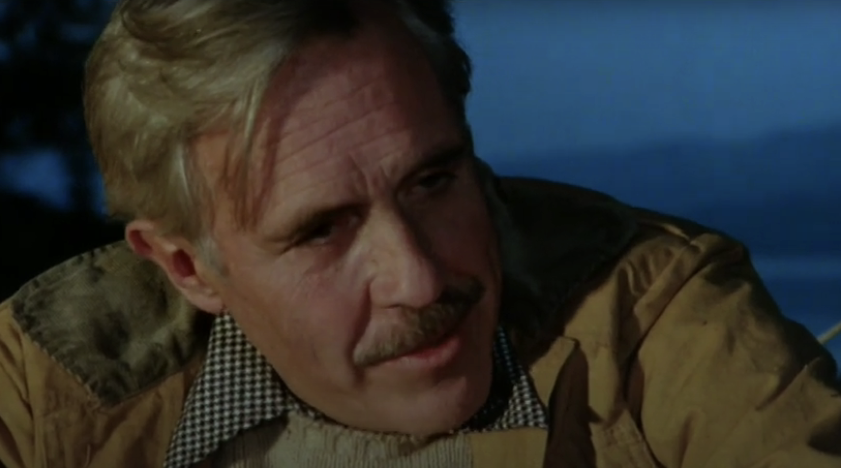 Jason Robards in &quot;Julia&quot; sitting at the beach with a fire going